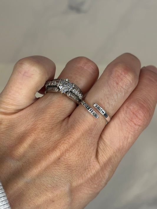 Adjustable silver wrap ring engraved with ‘Faith Over Fear'.