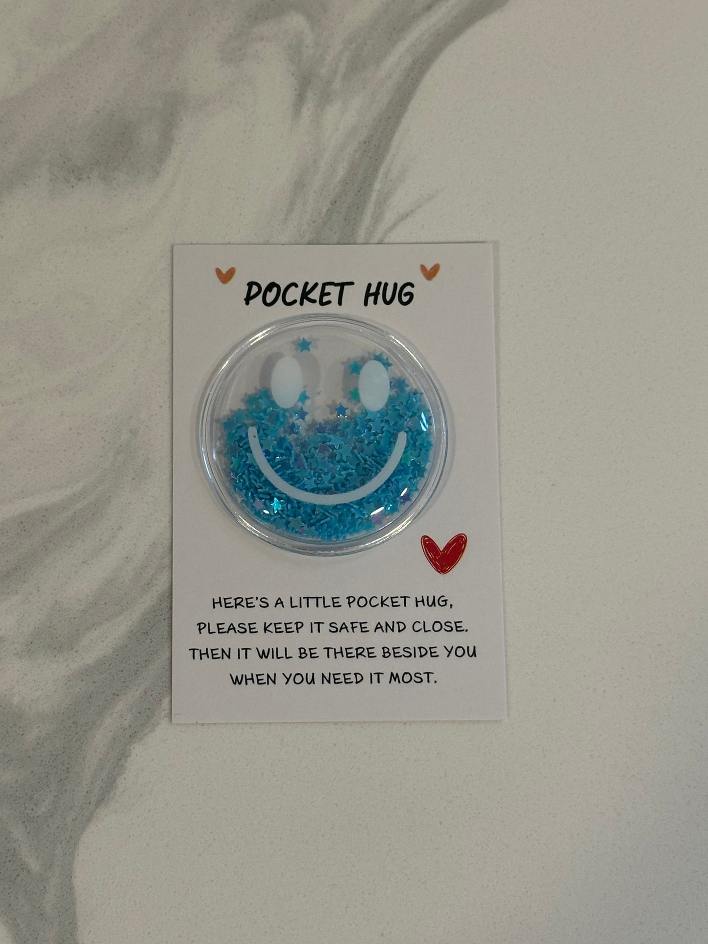 Glitter smiley Pocket Hug tokens on message cards in assorted colors