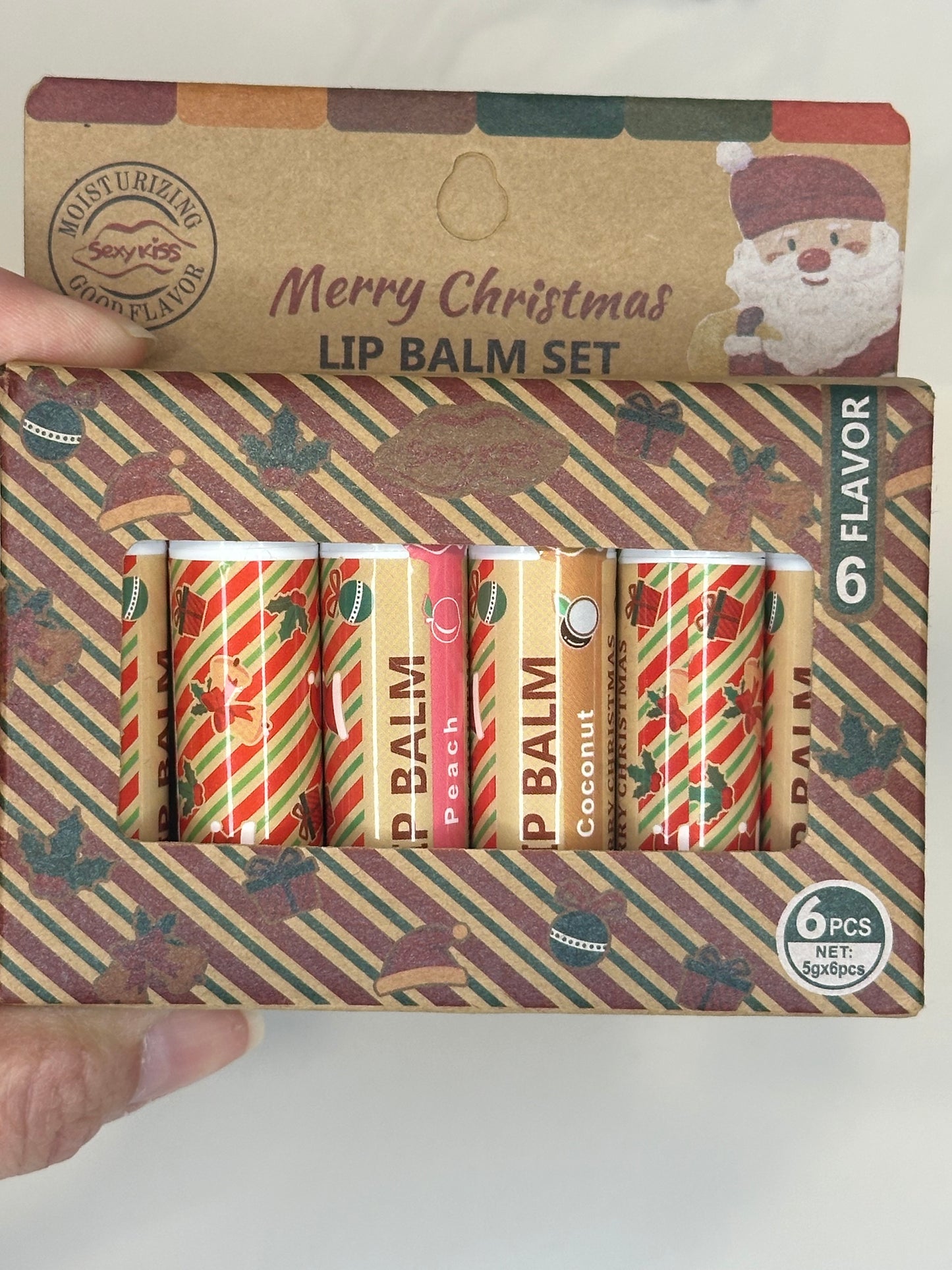 Holiday lip balm gift set with six Christmas-themed balms in festive packaging