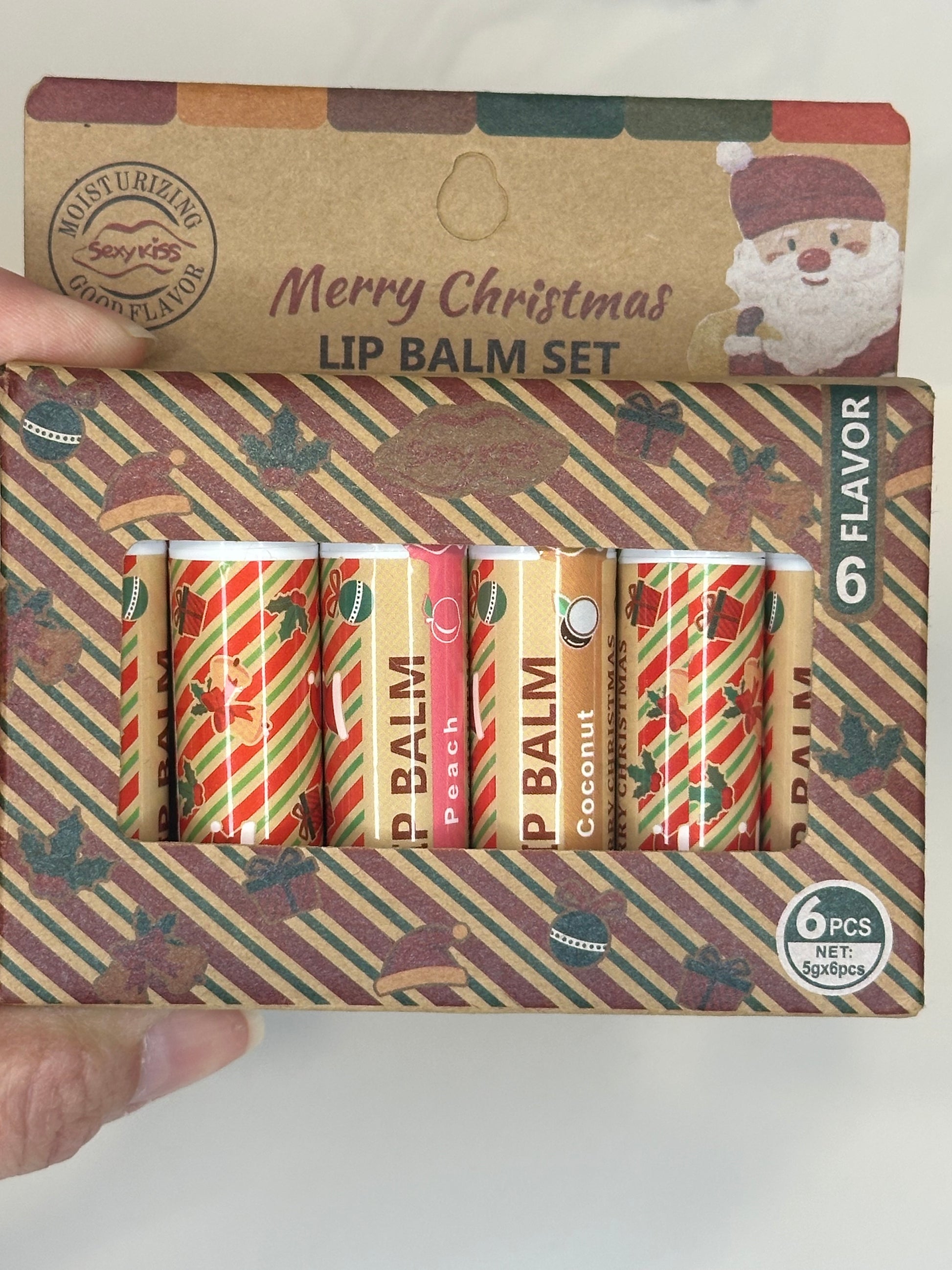 Holiday lip balm gift set with six Christmas-themed balms in festive packaging