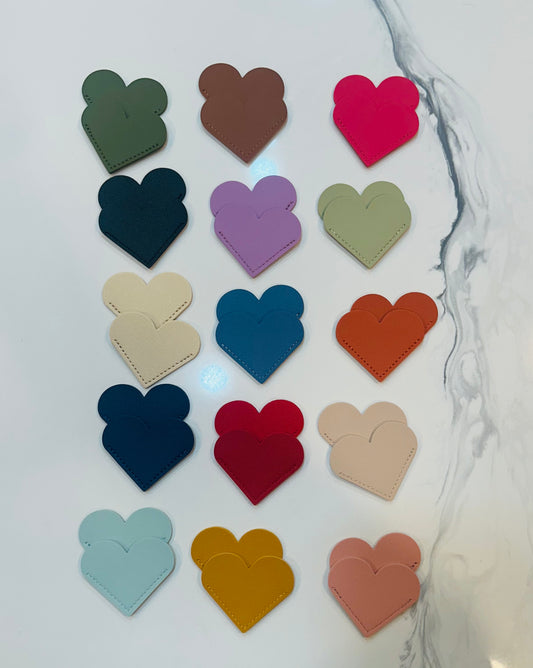 Faux leather heart corner bookmark in assorted colors.